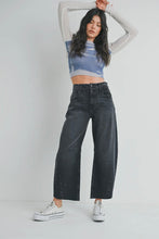 Load image into Gallery viewer, Woman wearing a blue crop top and black wide-leg jeans on a white background