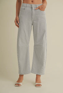 Person wearing light gray checkered pants on a beige background