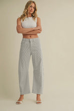 Load image into Gallery viewer, Woman wearing a white sleeveless top and light gray wide-leg jeans on a beige background