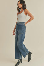 Load image into Gallery viewer, Woman wearing a light gray tank top and blue jeans on a beige background
