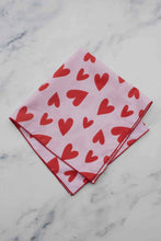Load image into Gallery viewer, Pink handkerchief with red heart patterns on a marble surface