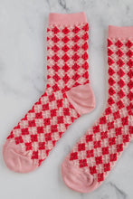 Load image into Gallery viewer, Red and white checkered socks with pink accents on a marble background