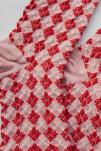 Load image into Gallery viewer, Red and white patterned fabric with a diamond design on a light gray background