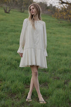 Load image into Gallery viewer, Woman in a white dress standing in a grassy field