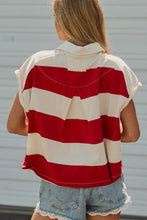 Load image into Gallery viewer, A woman viewed from behind wearing a red and off-white striped short-sleeve top and denim shorts against a light gray wall.