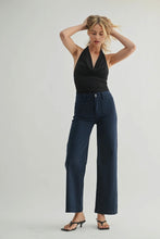 Load image into Gallery viewer, Woman wearing a black top and navy pants against a white background