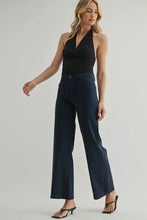 Load image into Gallery viewer, Woman wearing a black halter top and navy wide-leg pants on a plain background