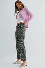 Load image into Gallery viewer, Woman wearing a pink sweater, white top, and polka dot pants on a light gray background