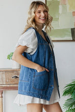 Load image into Gallery viewer, Woman wearing a denim apron over a white dress in a home setting.