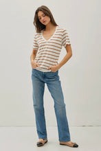 Load image into Gallery viewer, Woman wearing a striped shirt and blue jeans against a white background