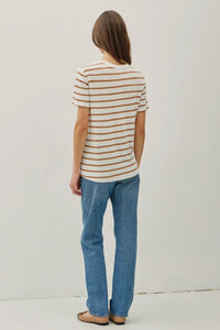 Person wearing a striped shirt and jeans on a plain background