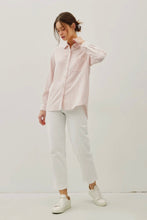 Load image into Gallery viewer, Woman wearing a light pink shirt and white pants on a plain background