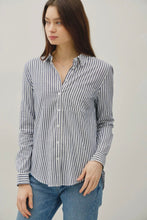 Load image into Gallery viewer, Woman wearing a striped shirt and jeans against a plain background