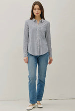 Load image into Gallery viewer, Woman wearing a striped shirt and blue jeans against a plain background