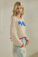 Load image into Gallery viewer, Woman wearing a cream sweater with colorful design, standing against a plain background