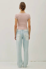 Load image into Gallery viewer, Person wearing a pink striped shirt and light blue jeans against a plain background