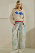 Load image into Gallery viewer, Woman wearing a sweater with fish design and patterned pants against a plain background
