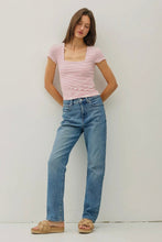 Load image into Gallery viewer, Woman wearing a striped shirt and blue jeans against a plain background