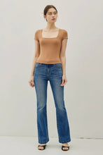 Load image into Gallery viewer, Woman wearing a brown top and blue jeans on a plain background