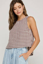 Load image into Gallery viewer, Woman wearing a checkered top and light blue jeans against a plain background