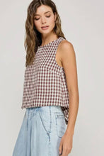 Load image into Gallery viewer, Woman wearing a checkered top and light blue jeans against a plain background