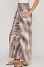 Load image into Gallery viewer, Checkered pants worn by a person on a plain background