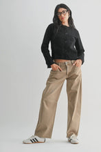 Load image into Gallery viewer, Person wearing a black cropped jacket and beige pants on a white background