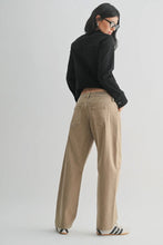 Load image into Gallery viewer, Person wearing a black top and beige pants on a light gray background