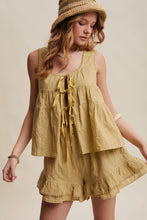 Load image into Gallery viewer, Woman wearing a yellow dress and straw hat on a beige background