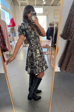 Load image into Gallery viewer, Person wearing a floral dress and black boots in a store setting