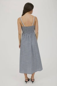 Woman wearing a gray striped dress on a white background