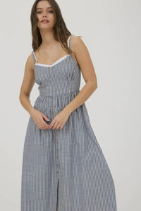 Woman wearing a striped dress on a plain background