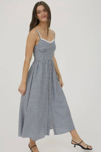 Woman wearing a blue and white striped dress on a plain background