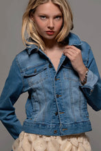 Load image into Gallery viewer, Woman wearing a blue denim jacket against a gray background
