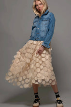 Load image into Gallery viewer, Woman wearing a denim jacket and textured beige skirt on a gray background