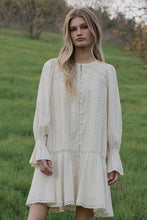 Load image into Gallery viewer, Woman wearing a white lace dress standing in a grassy field with trees in the background