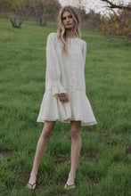 Load image into Gallery viewer, Woman in a white dress standing in a grassy field