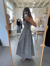 Load image into Gallery viewer, Person wearing a black and white checkered dress in a clothing store.