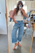 Load image into Gallery viewer, A woman takes a mirror selfie in a clothing boutique, wearing a white ribbed tank top and light-wash wide-leg cuffed jeans.