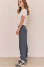 Load image into Gallery viewer, Person wearing a white top and gray pants standing against a plain background