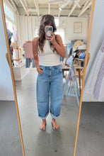 Load image into Gallery viewer, A woman takes a mirror selfie in a boutique, wearing a white ribbed tank top and light-wash blue cuffed jeans.