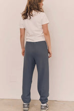 Load image into Gallery viewer, Person wearing a white t-shirt and gray sweatpants against a plain background