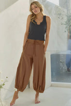 Load image into Gallery viewer, Woman wearing a dark gray tank top and brown wide-leg pants indoors.