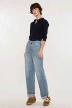 Load image into Gallery viewer, A model wearing a dark navy long-sleeve polo shirt, light-wash wide-leg blue jeans, and brown suede shoes, standing against a plain white studio background.