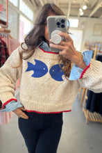 Load image into Gallery viewer, Person wearing a sweater with fish designs in a store setting