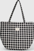 Load image into Gallery viewer, Black and white checkered tote bag with a visible brand label on a light gray background