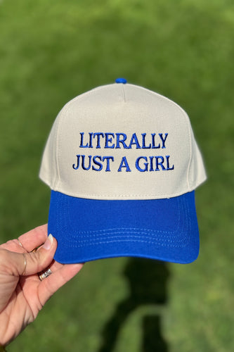 Cap with 'Literally Just a Girl' text held against a green background