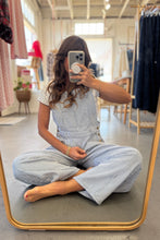 Load image into Gallery viewer, Woman taking a mirror selfie wearing a light blue checkered outfit in a clothing store.