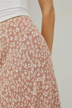 Load image into Gallery viewer, Close-up of a floral skirt with a plain background