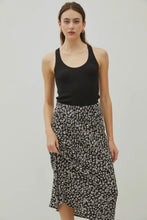 Load image into Gallery viewer, Woman wearing a black tank top and floral skirt against a plain background